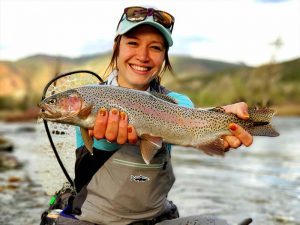 rainbow trout caught by woman fly fishing in colorado