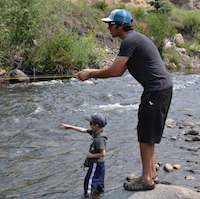 13045-Minturn Anglers Wade Guide School-guide teaching a boy how to catch fish