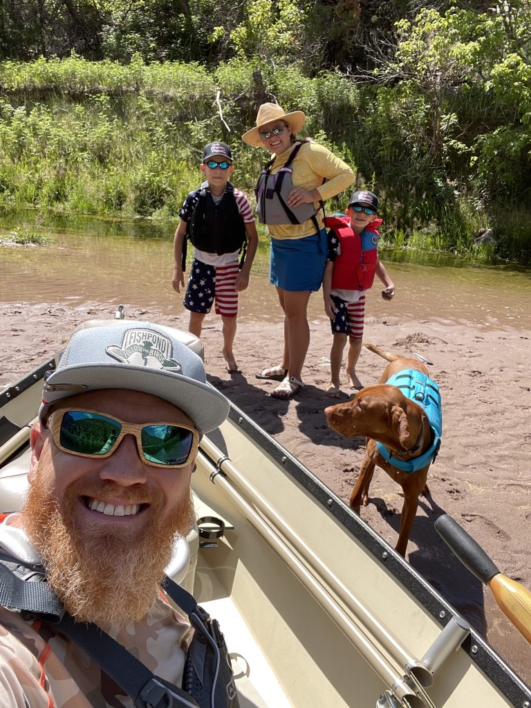 Float Fishing Guide Part 1 — The Boat, man in boat taking selfie of family and dog float fishing on a sunny day